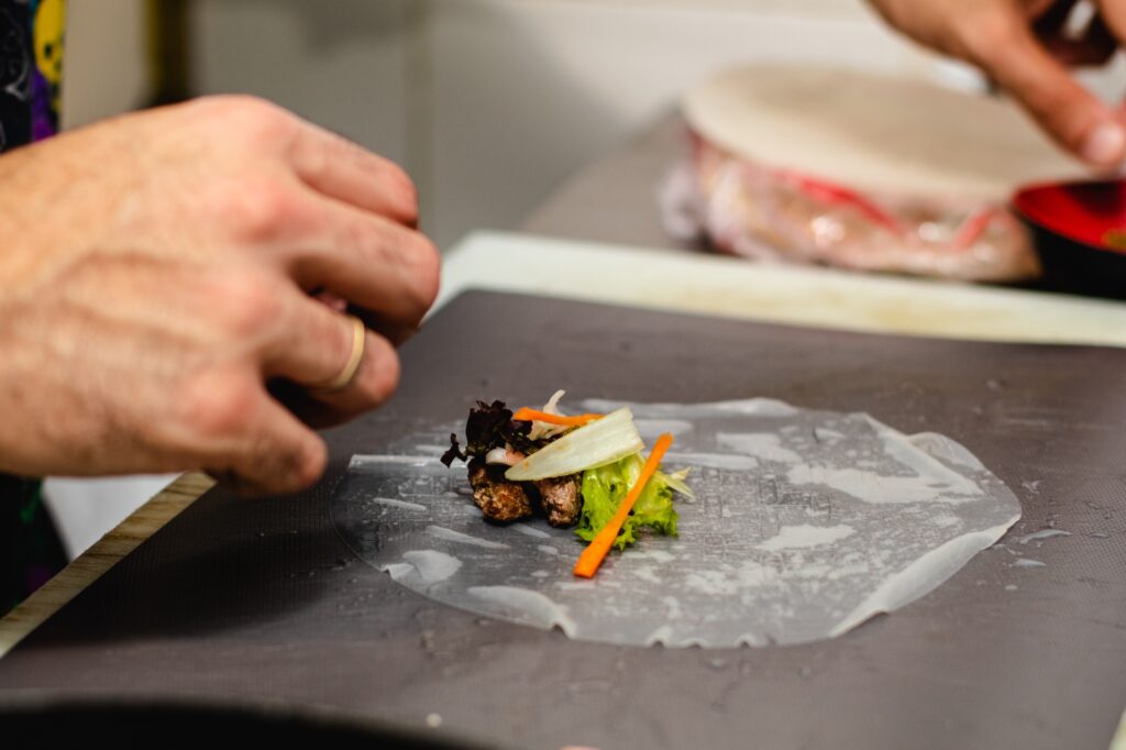 Making Vietnamese traditional spring rolls by hands in a restaurant